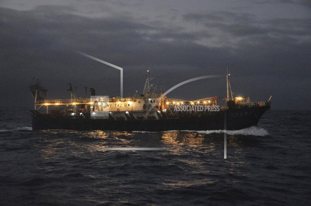 Joshua Goodman The Chinese-flagged Lu Rong Yuan Yu 609 prepares to fish for squid on the high seas near the Galapagos Islands on July 19, 2021. Fishing takes place almost exclusively at night when each ship turns on hundreds of lights as powerful than anything at a stadium to attract swarms of the fast-flying squid. The concentration of lights is so intense it can be seen from space on satellite images that show the massive fleet shining as brightly as major cities hundreds of miles away on land. (AP Photo/Joshua Goodman)