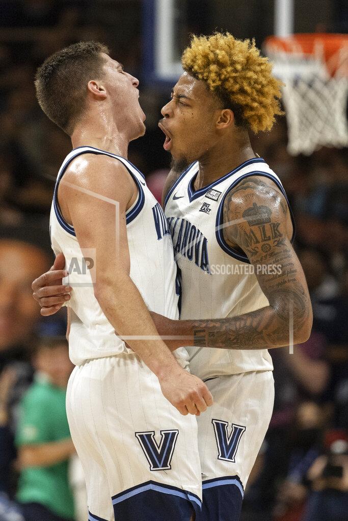 Laurence Kesterson Villanova guard Collin Gillespie, left, and guard Justin Moore chest bump after Moore made a three point shot during the second half of an NCAA college basketball game against Marquette, Wednesday, Jan. 19, 2022, in Villanova, Pa. (AP Photo/Laurence Kesterson)