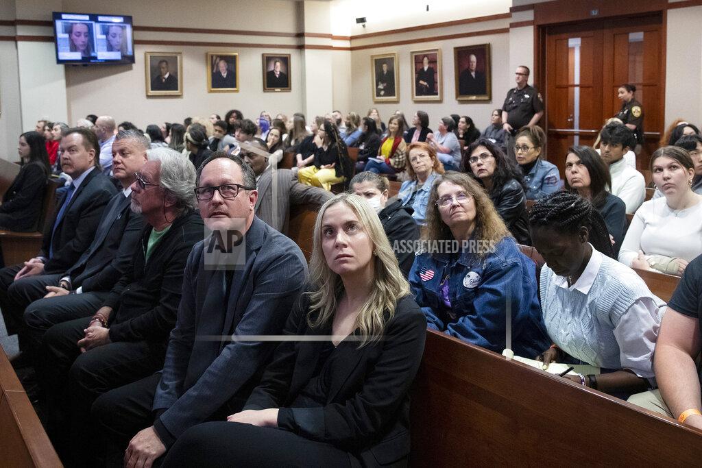 Michael Reynolds Spectators in court look at monitors in the courtroom in the Fairfax County Circuit Courthouse in Fairfax, Va., Thursday, May 26, 2022. Actor Johnny Depp sued his ex-wife Amber Heard for libel in Fairfax County Circuit Court after she wrote an op-ed piece in The Washington Post in 2018 referring to herself as a "public figure representing domestic abuse." (Michael Reynolds/Pool Photo via AP)