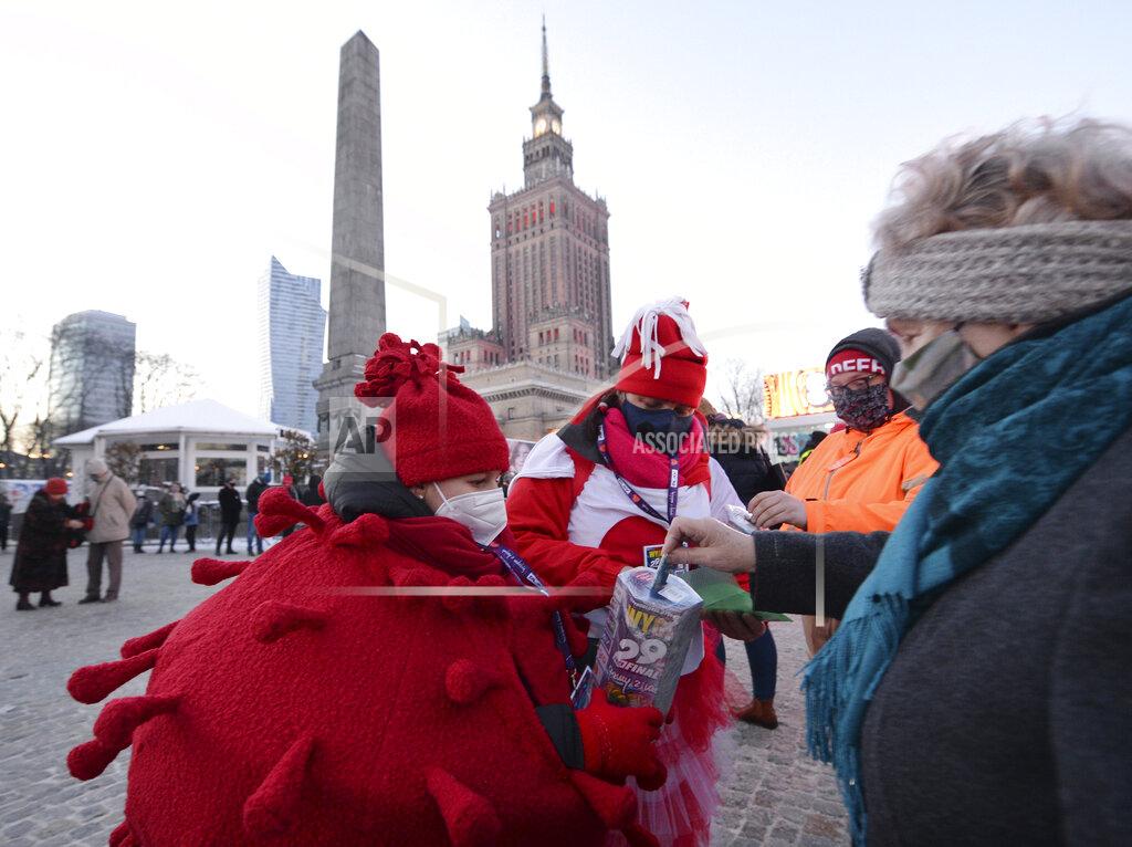 Czarek Sokolowski A child in a red costume collects money for Poland's most popular nationwide fundraiser for health purposes, the Great Orchestra of Christmas Charity, that was postponed by two weeks due to the pandemic, in downtown Warsaw, Poland, on Sunday, Jan. 31, 2021. Anti-government protesters angry about a near-total abortion ban suspended their marches for the weekend to show solidarity and ensure that they didn't steal the spotlight from the event. (AP Photo/Czarek Sokolowski)