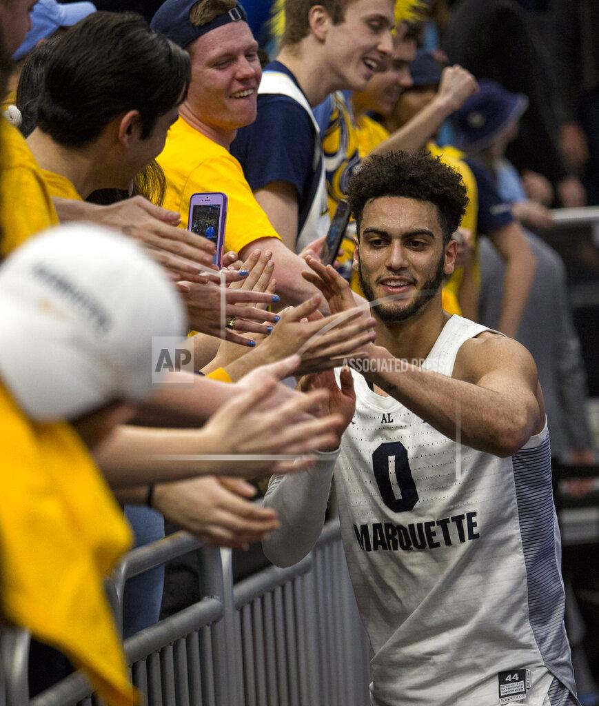 Darren Hauck Marquette guard Markus Howard celebrate with fans after defeating Villanova during an NCAA college basketball game Saturday, Feb. 9, 2019, in Milwaukee. Marquette defeated Villanova 66-65. (AP Photo/Darren Hauck)