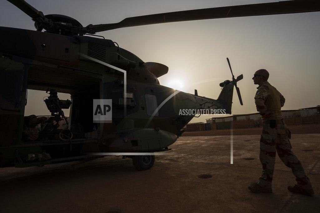 Uncredited A French Barkhane force soldier inspects a Caiman transport helicopter before going on a night mission in Gao, Mali Monday June 7, 2021. After France suspended joint military operations with Malian forces after the junta led by Col. Assimi Goita retook control of Mali's transitional government May 24 2021, French President Emmanuel Macron announced at a press conference Thursday June 10, 2021 that operation Barkhane would end and be replaced by support for local partners and counter terrorism. (AP Photo/Jerome Delay)