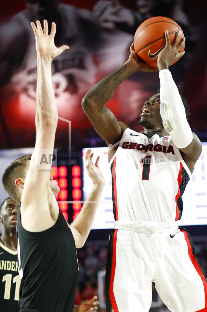 Joshua L. Jones Georgia guard Teshaun Hightower (1) takes a shot while being defended by Vanderbilt forward Matt Ryan (32) during an NCAA college basketball game, Wednesday, Jan. 9, 2019 in Athens, Ga. (Joshua L. Jones/Athens Banner-Herald via AP)