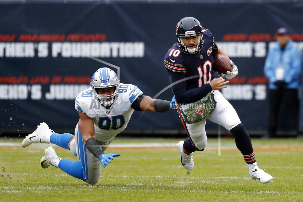 Charles Rex Arbogast Chicago Bears quarterback Mitchell Trubisky (10) avoids a tackle byf Detroit Lions defensive end Trey Flowers (90) during the second half of an NFL football game in Chicago, Sunday, Nov. 10, 2019. (AP Photo/Charles Rex Arbogast)