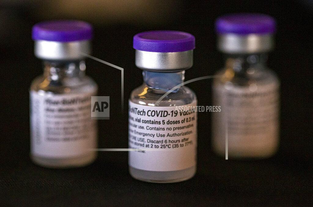 Andy Abeyta Vials of the Pfizer-BioNTech COVID-19 vaccine are seen ready to be used as healthcare workers receive the first doses of the vaccine at the University of Iowa Hospitals and Clinics, Monday, Dec. 14, 2020, in Iowa City, Iowa. (Andy Abeyta/The Gazette via AP)