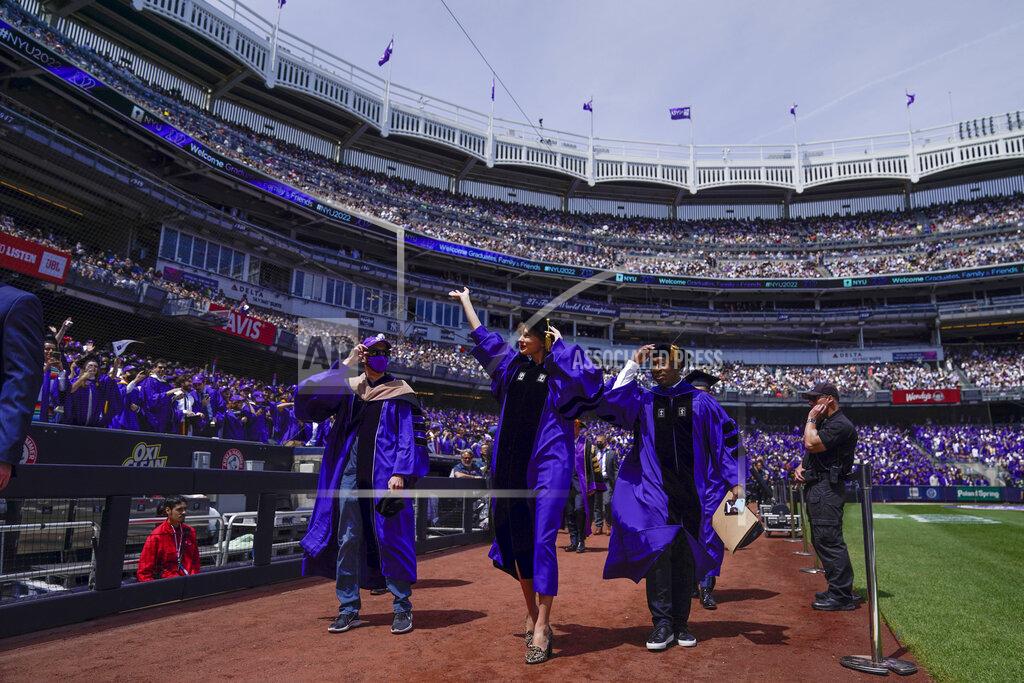 Seth Wenig Taylor Swift, center, waves to graduates as she participates in a graduation ceremony for New York University at Yankee Stadium in New York, Wednesday, May 18, 2022. (AP Photo/Seth Wenig)