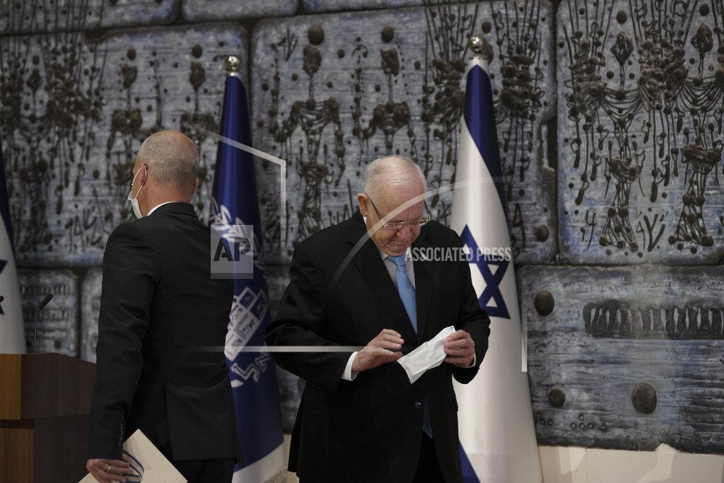 Maya Alleruzzo Chairman of Israel's Central Elections Committee Judge Uzi Fogelman, left, leaves the podium after handing the official election results to Israeli President Reuvin Rivlin, right, in Jerusalem, Wednesday, March 31, 2021. (AP Photo/Maya Alleruzzo).