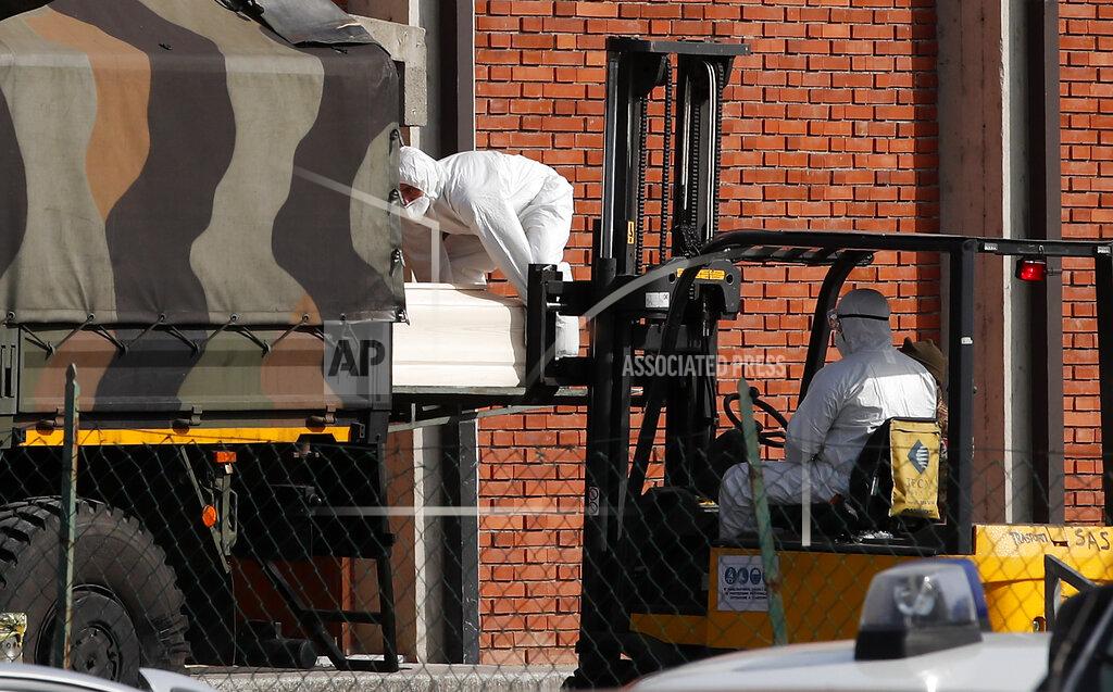 Antonio Calanni FILE - In this March 28, 2020 file photo, a coffin is loaded onto a military truck to be taken with several others to crematoriums in Venice and Udine, from the San Giuseppe church in Seriate, near Bergamo, northern Italy. Italy is poised to reclaim the dishonor of reporting the most coronavirus deaths in Europe, as the second surge ravages the country’s disproportionately old population and exposes how public health shortfalls and delayed restrictions compounded a lack of preparedness going into the pandemic. (AP Photo/Antonio Calanni, file)