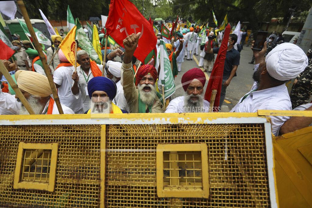 Manish Swarup Farmers shout anti government slogans during a protest in New Delhi, India, Thursday, July 22, 2021. More than 200 farmers on Thursday began a protest near India's Parliament to mark eight months of their agitation against new agricultural laws that they say will devastate their income. (AP Photo/Manish Swarup)
