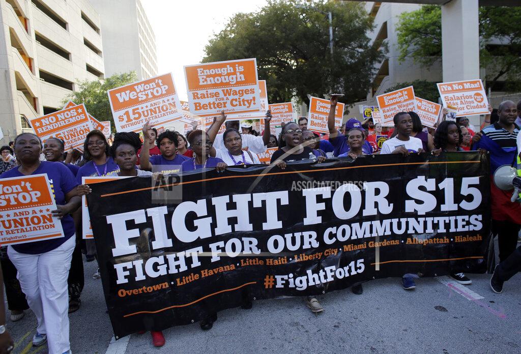 Lynne Sladky FILE - In this April 15, 2015, file photo, protesters march in support of raising the minimum wage to $15 an hour as part of an expanding national movement known as Fight for 15, in Miami. A national coalition of labor unions, along with racial and social justice organizations, will stage a mass walkout from work July 20, 2020, as part of an ongoing reckoning on systemic racism and police brutality in the U.S. (AP Photo/Lynne Sladky, File)