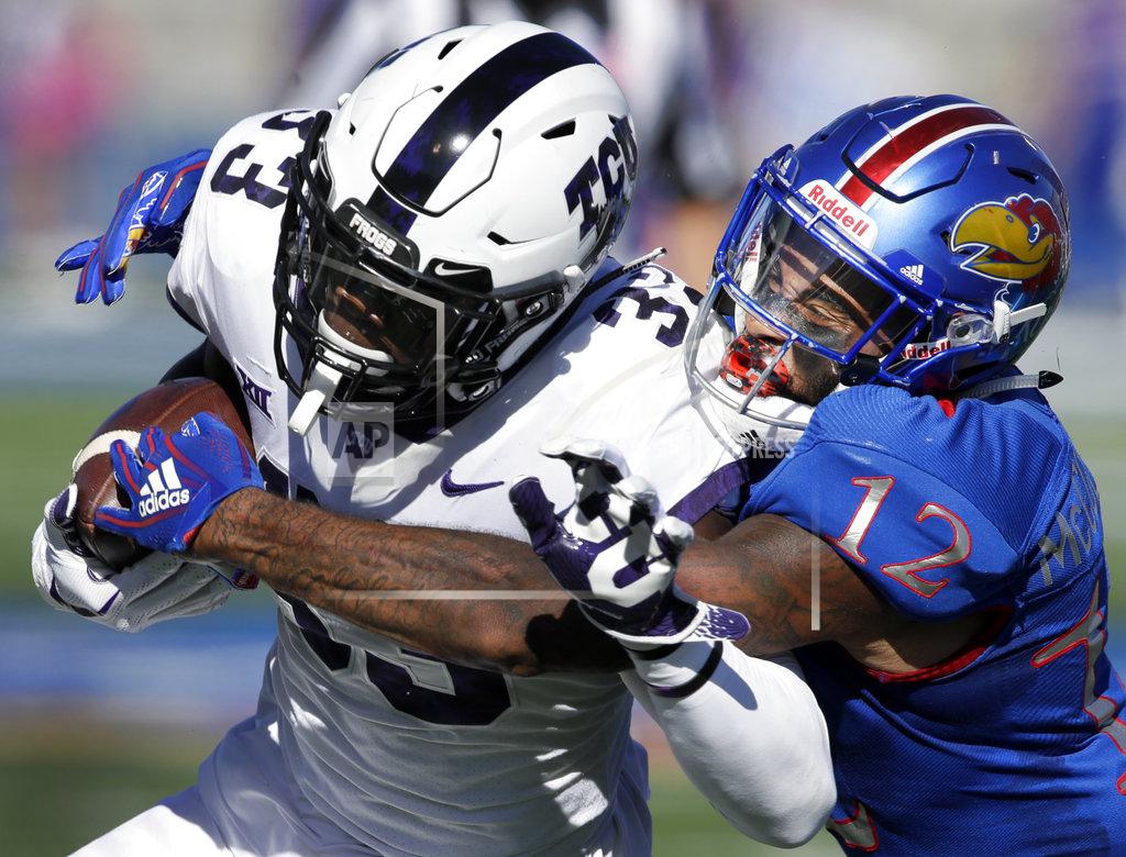 Orlin Wagner TCU running back Sewo Olonilua (33) is tackled by Kansas safety Jeremiah McCullough (12) during the first half of an NCAA college football game in Lawrence, Kan., Saturday, Oct. 27, 2018. (AP Photo/Orlin Wagner)