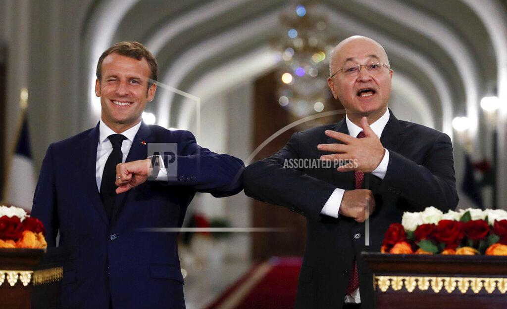 Gonzalo Fuentes Iraqi President Barham Salih, right, and French President Emmanuel Macron greet each other with an elbow bump during a joint press conference at the Salam Palace Wednesday, Sept. 2, 2020 in Baghdad. French President Emmanuel Macron is the first head of state to visit the Iraqi capital since Prime Minister Mustafa al-Kadhimi, Iraq's former intelligence chief, formed a new government in May. (Gonzalo Fuentes/Pool via AP)