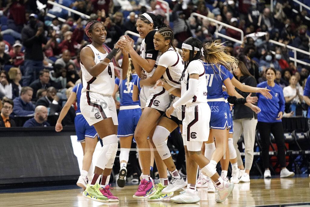 Gerry Broome South Carolina forward Aliyah Boston (4) celebrates with teammates center Kamilla Cardoso, guard LeLe Grissett and guard Destanni Henderson, right, late in the second half of a college basketball game in the Elite 8 round of the NCAA tournament in Greensboro, N.C., Sunday, March 27, 2022. (AP Photo/Gerry Broome)