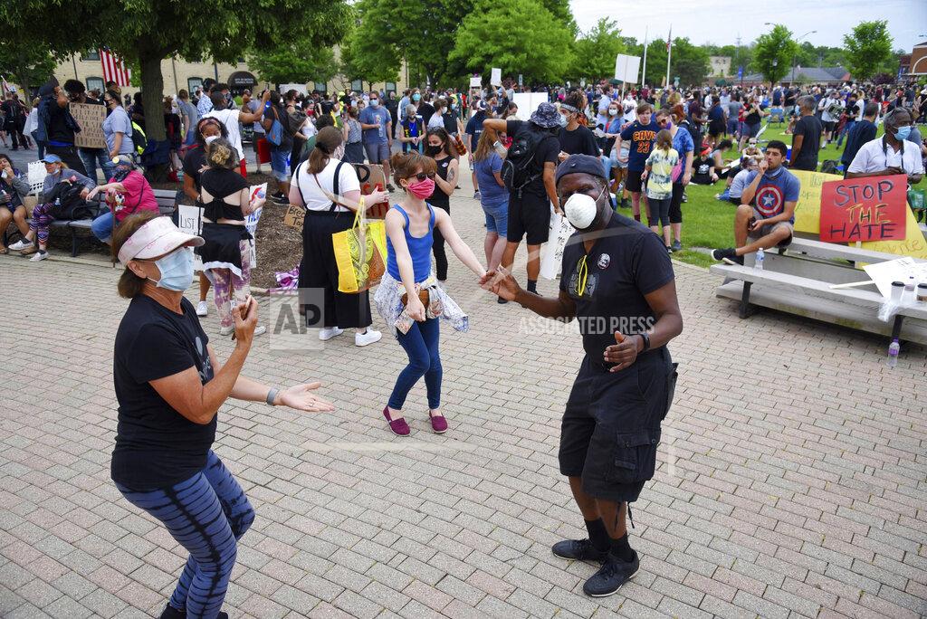 John Starks Several people dance at a Black Lives Matter rally for George Lloyd, a black man who died while being restrained by Minneapolis police on Memorial Day, at the Peg Bond Pavilion in Batavia Wednesday, June 3, 2020. (John Starks/Daily Herald, via AP)