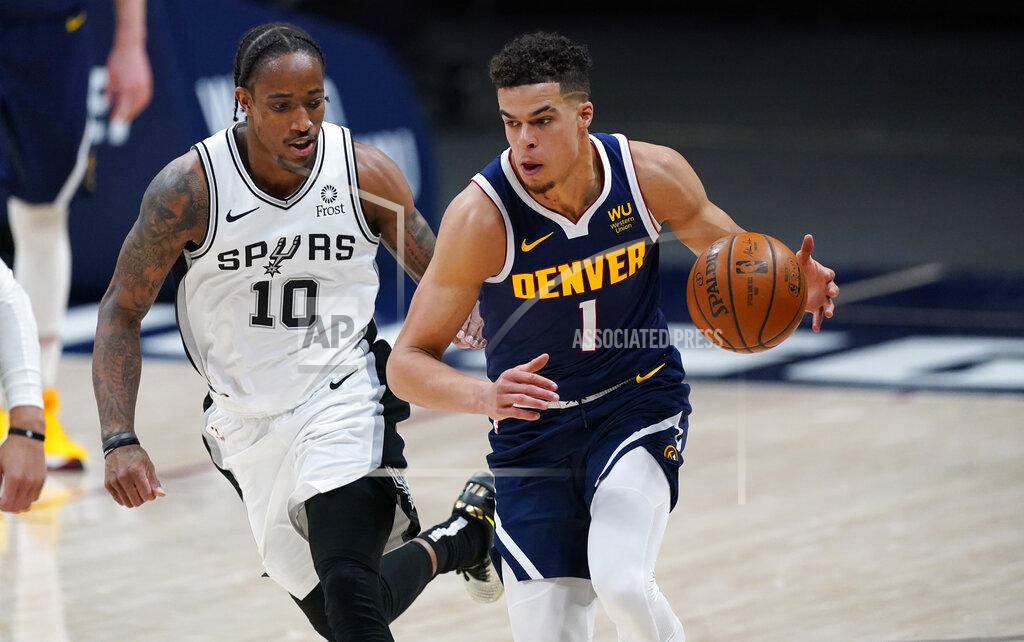 David Zalubowski Denver Nuggets forward Michael Porter Jr., right, collects the ball as San Antonio Spurs forward DeMar DeRozan defends in the second half of an NBA basketball game Friday, April 9, 2021, in Denver. (AP Photo/David Zalubowski)