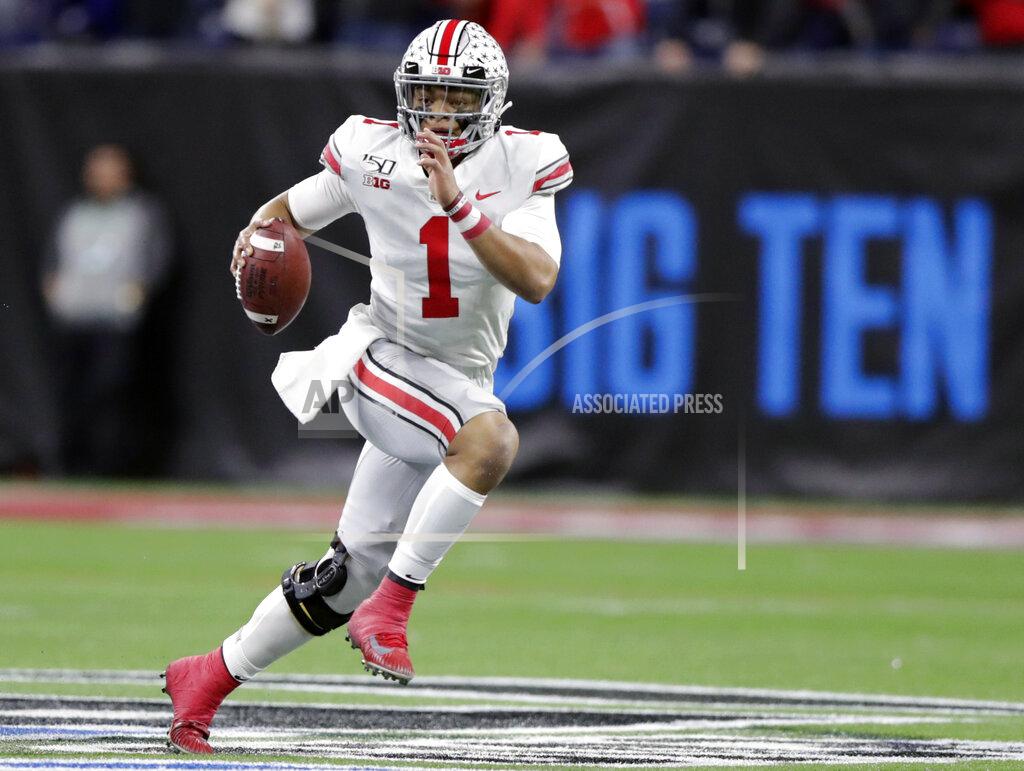 Michael Conroy FILE - In this Dec. 7, 2019, file photo, Ohio State quarterback Justin Fields (1) runs with the ball against Wisconsin during the first half of the Big Ten championship NCAA college football game, in Indianapolis. Big Ten is going to give fall football a shot after all. Less than five weeks after pushing football and other fall sports to spring in the name of player safety during the pandemic, the conference changed course Wednesday, Sept. 16, 2020, and said it plans to begin its season the weekend of Oct. 23-24. (AP Photo/Michael Conroy, File)
