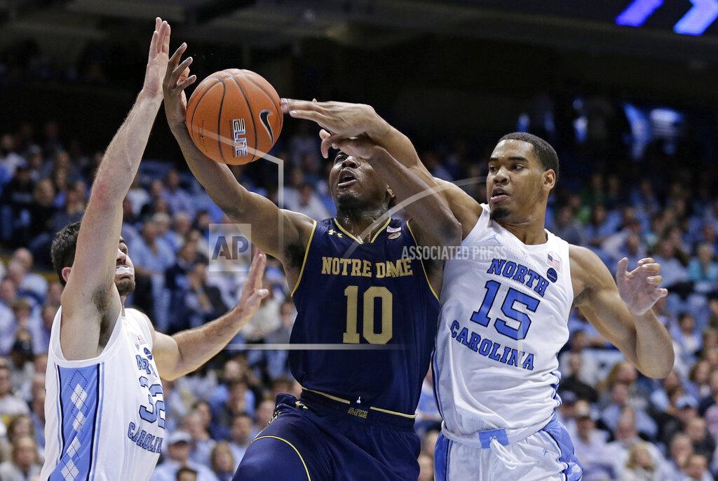 Gerry Broome North Carolina's Luke Maye, left, and Garrison Brooks (15) guard Notre Dame's TJ Gibbs (10) during the second half of an NCAA college basketball game in Chapel Hill, N.C., Tuesday, Jan. 15, 2019. North Carolina won 75-69. (AP Photo/Gerry Broome)
