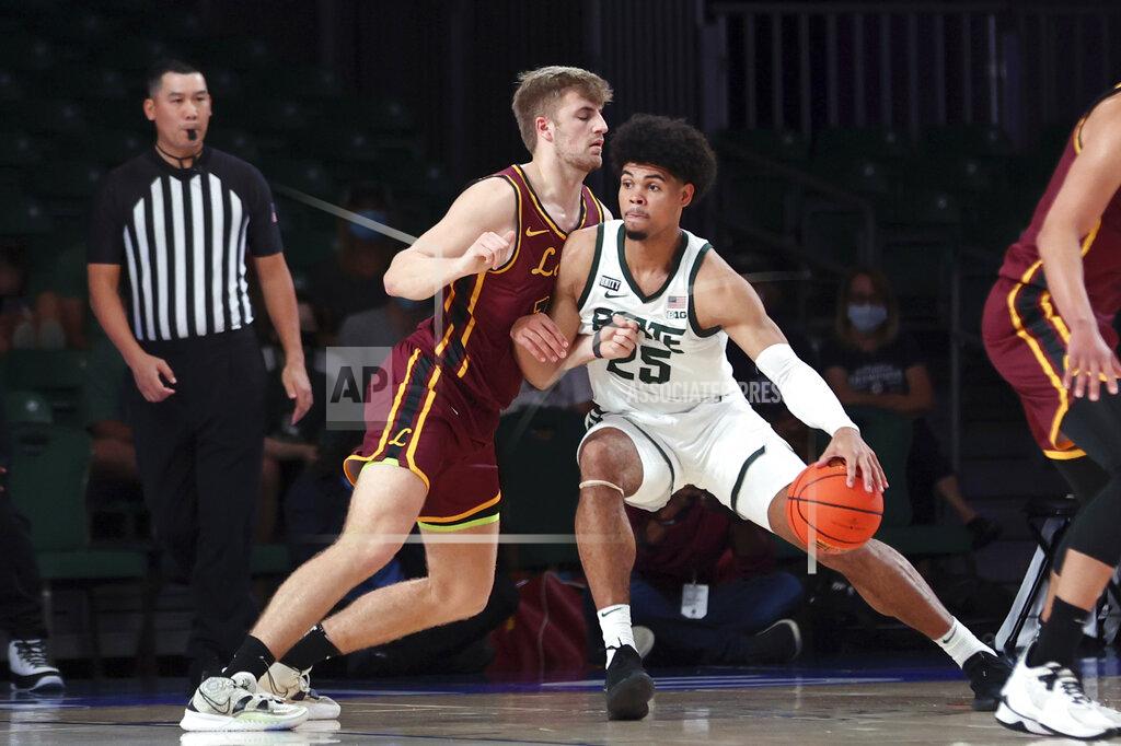 Tim Aylen In a photo provided by Bahamas Visual Services, Michigan State forward Malik Hall (25) looks for an outlet as Loyola-Chicago forward Tom Welch (10) defends during an NCAA college basketball game at Paradise Island, Bahamas, Wednesday, Nov. 24, 2021. (Tim Aylen/Bahamas Visual Services via AP)