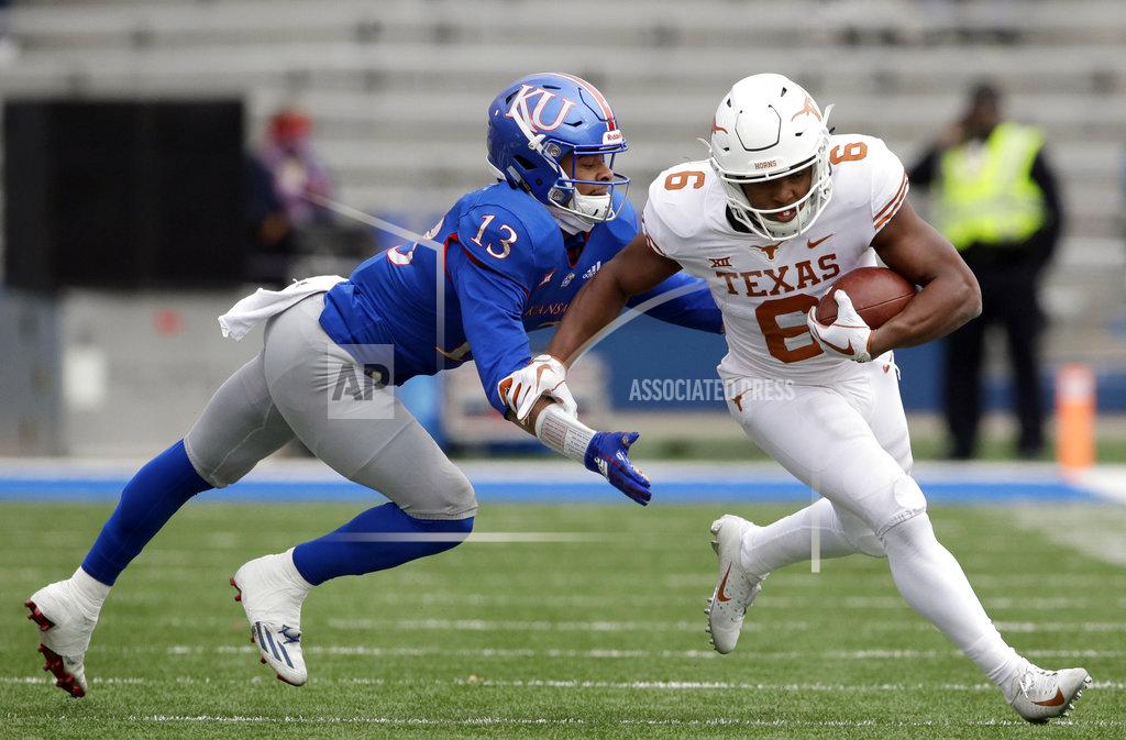 Orlin Wagner Texas wide receiver Devin Duvernay (6) gets past Kansas cornerback Hasan Defense (13) during the first half of an NCAA college football game in Lawrence, Kan., Friday, Nov. 23, 2018. (AP Photo/Orlin Wagner)