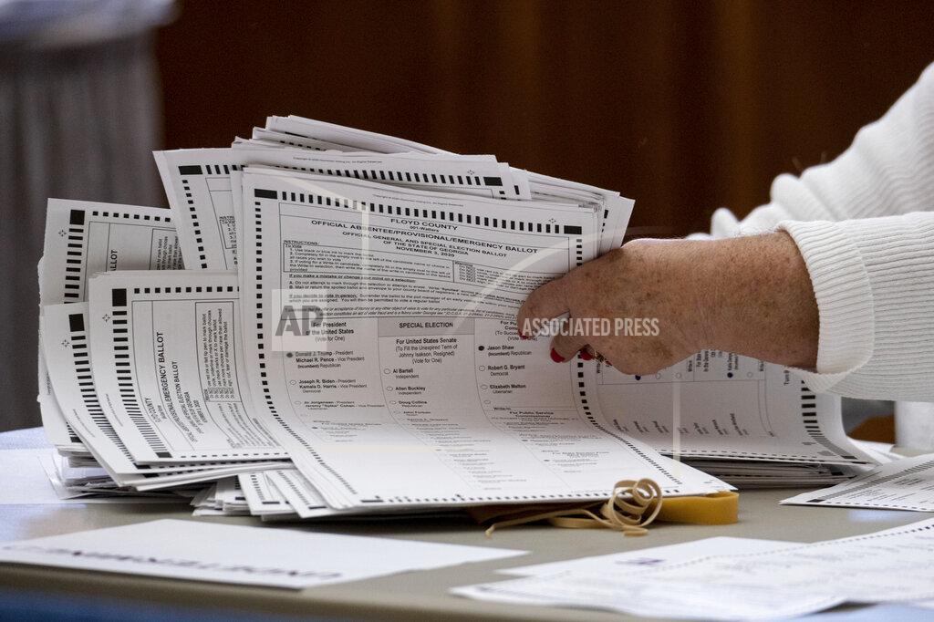 Ben Gray Officials sort ballots during an audit at the Floyd County administration building in Rome, Ga. on Friday morning, Nov. 13, 2020. Election officials in Georgia’s 159 counties are undertaking a hand tally of the presidential race that stems from an audit required by state law. (AP Photo/Ben Gray)