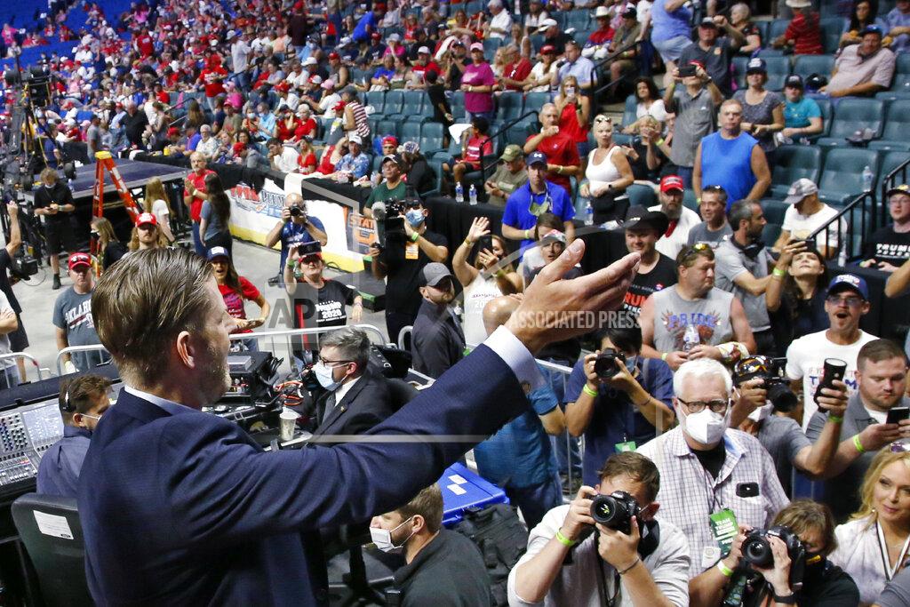 Sue Ogrocki Eric Trump, the son of President Donald Trump, waves to supporters before a rally in Tulsa, Okla., Saturday, June 20, 2020. (AP Photo/Sue Ogrocki)
