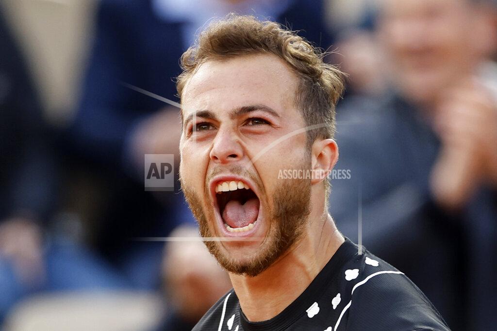 Jean-Francois Badias France's Hugo Gaston shouts after winning a point as he plays Australia's Alex de Minaur during their first round match of the French Open tennis tournament at the Roland Garros stadium Tuesday, May 24, 2022 in Paris. (AP Photo/Jean-Francois Badias)