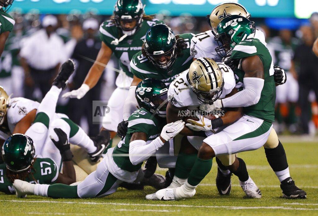 Noah K. Murray New Orleans Saints' Dwayne Washington (27) is tackled by New York Jets' Alex Brown (25), Neville Hewitt and Bronson Kaufusi (91) during the first half of a preseason NFL football game Saturday, Aug. 24, 2019, in East Rutherford, N.J. (AP Photo/Noah K. Murray)