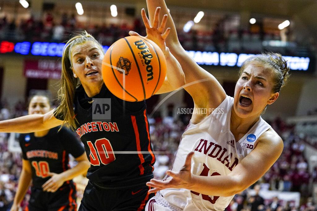 Michael Conroy Princeton forward Ellie Mitchell (00) and Indiana forward Aleksa Gulbe (10) reach for the ball as they go for a long rebound in the second half of a college basketball game in the second round of the NCAA tournament in Bloomington, Ind., Monday, March 21, 2022. Indiana defeated Princeton 56-55. (AP Photo/Michael Conroy)