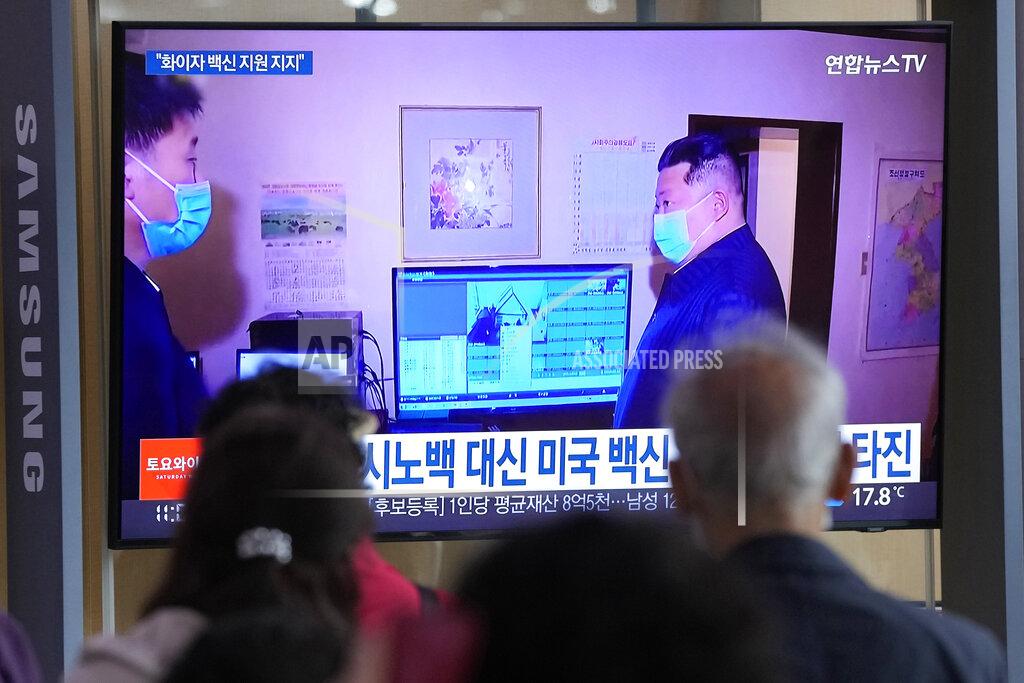 Ahn Young-Joon People watch a TV screen showing a file image of North Korean leader Kim Jong Un, right, during a news program at a train station in Seoul, South Korea, Saturday, May 14, 2022. North Korea on Saturday reported 21 new deaths and 174,440 more people with fever symptoms as the country scrambles to slow the spread of COVID-19 across its unvaccinated population. (AP Photo/Ahn Young-joon)
