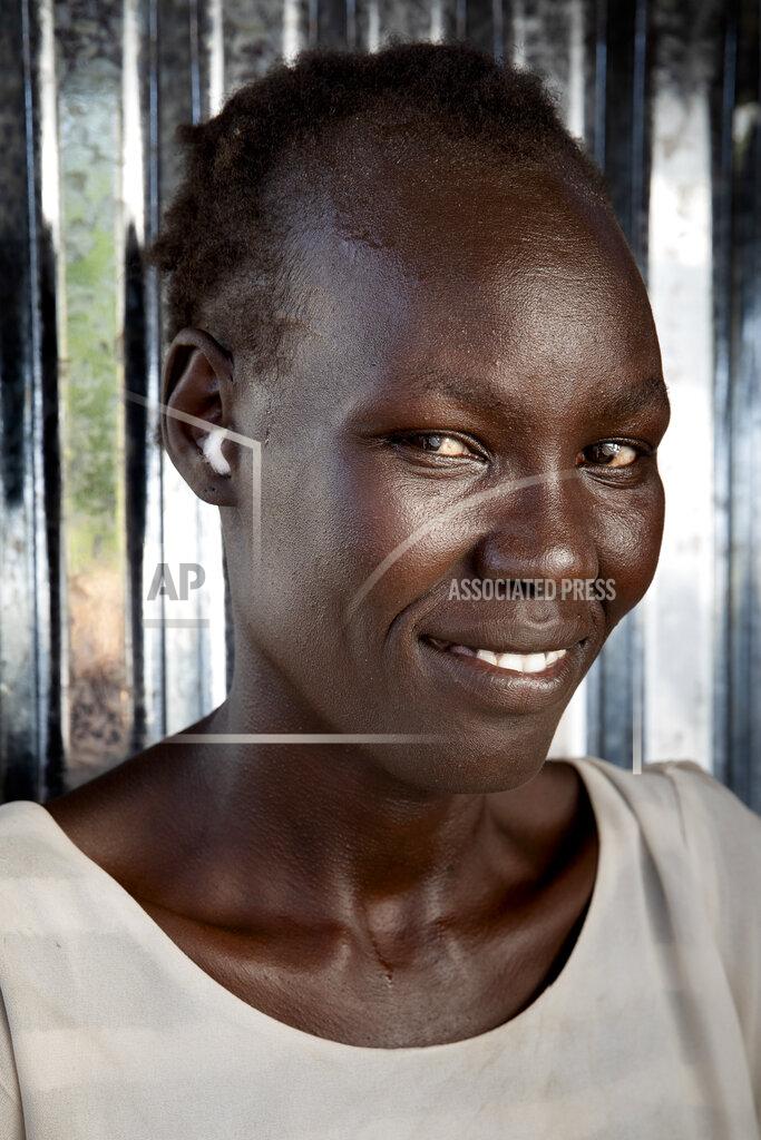 Adrienne Surprenant Belinda Idjidio, 36-years-old mother of 5, poses for a portrait at Paska Itwari Beda's Juba, South Sudan home, Saturday, May 29, 2021. With resources scarce, Beda and nine women formed a group that meets and contributes two of the barest necessities for warding off hunger and illness - money and bars of soap. They gather on Fridays, pooling supplies and handing them out to a different family every week. Over coffee, they share advice. (AP Photo/Adrienne Surprenant)