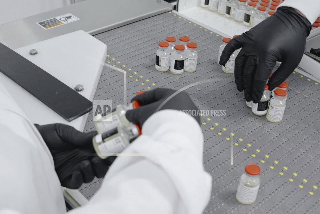 Uncredited In this undated image from video provided by Regeneron Pharmaceuticals on Friday, Oct. 2, 2020, vials are inspected at the company's facilities in New York state, for efforts on an experimental coronavirus antibody drug. Antibodies are proteins the body makes when an infection occurs; they attach to a virus and help the immune system eliminate it. (Regeneron via AP)