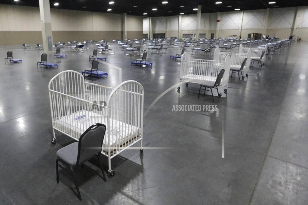 FILE - In this Monday, April 6, 2020 file photo, cots and cribs are arranged at the Mountain America Expo Center in Sandy, Utah, as an alternate care site or for hospital overflow amid the COVID-19 pandemic. According to a government report released on Wednesday, May 5, 2021, the U.S. birth rate fell 4% in 2020, the largest single-year decrease in nearly 50 years. The rate dropped for moms of every major race and ethnicity, and in nearly every age group, falling to the lowest point since federal health officials started tracking it more than a century ago. (AP Photo/Rick Bowmer)