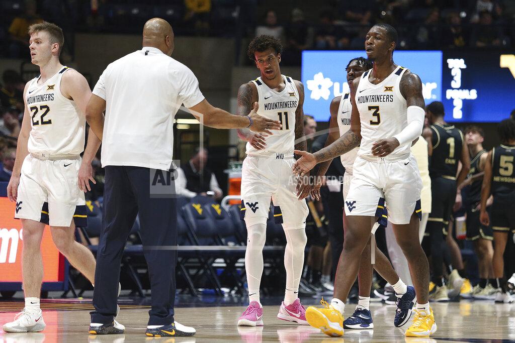 Kathleen Batten West Virginia forwards Jalen Bridges (11) and Gabe Osabuohien (3) celebrate after a score against Oakland during the second half of an NCAA college basketball game in Morgantown, W.Va., Tuesday, Nov. 9, 2021. (AP Photo/Kathleen Batten)