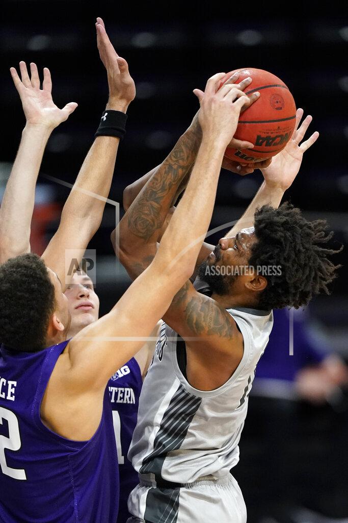 Nam Y. Huh Chicago State forward Aaris-Monte Bonds, right, shoots against Northwestern forward Robbie Beran and forward Pete Nance during the first half of an NCAA college basketball game in Evanston, Ill., Saturday, Dec. 5, 2020. (AP Photo/Nam Y. Huh)