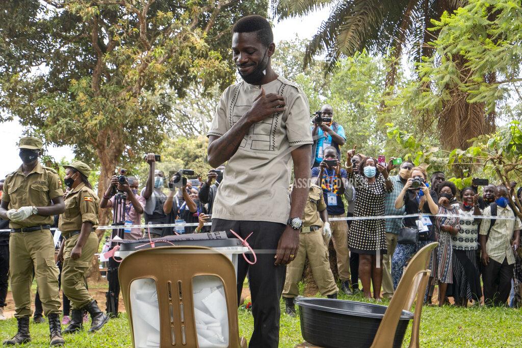 Jerome Delay Uganda's leading opposition challenger Bobi Wine makes the sign of the cross after voting in Kampala, Uganda, Thursday, Jan. 14, 2021. Ugandans are voting in a presidential election tainted by widespread violence that some fear could escalate as security forces try to stop supporters of Wine from monitoring polling stations.(AP Photo/Jerome Delay)