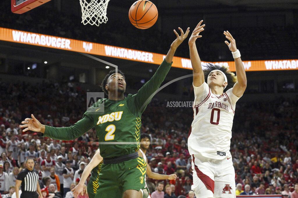 Michael Woods North Dakota State guard Tajavis Miller (2) and Arkansas guard Anthony Black (0) go after a rebound during the second half of an NCAA college basketball game Monday, Nov. 7, 2022, in Fayetteville, Ark. (AP Photo/Michael Woods)