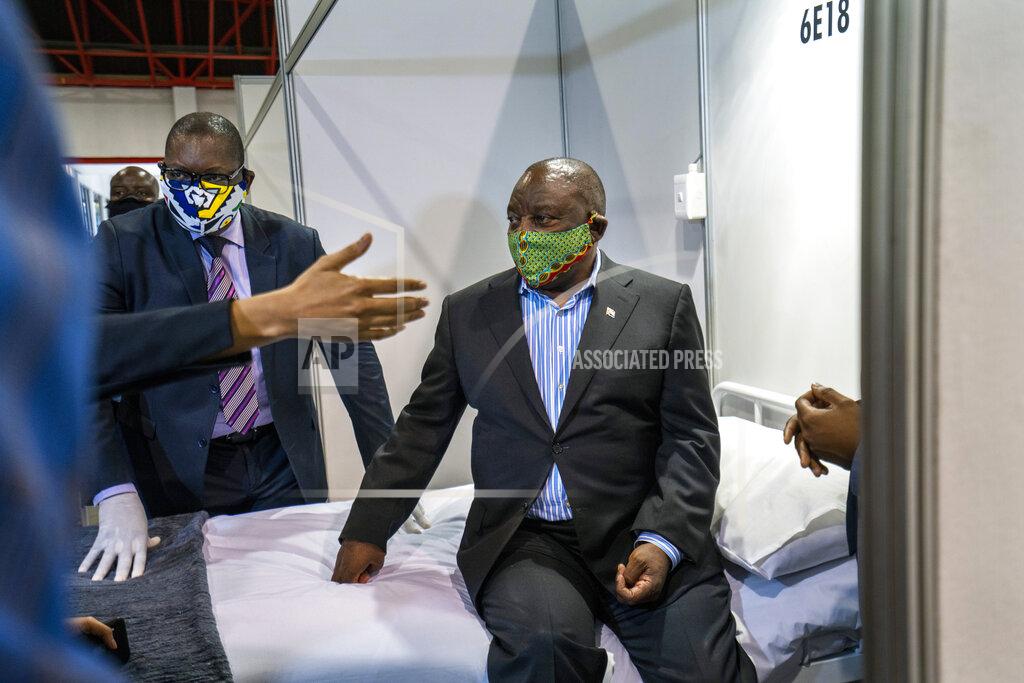 Jerome Delay FILE- In this file photo taken Friday, April 24, 2020, South African President Cyril Ramaphosa visits the COVID-19 treatment facilities at the NASREC Expo Centre in Johannesburg, South Africa. South Africa is struggling to balance its fight against the coronavirus with its dire need to resume economic activity. The country with the Africa’s most developed economy also has its highest number of infections — more than 19,000. (AP Photo/Jerome Delay, File)