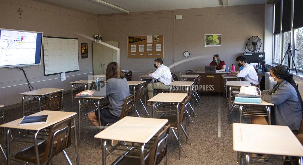 Emily Matthews Students learn in-person and virtually in Miss Courtney Choura's geometry class at Seton LaSalle Catholic High School, Wednesday, March 3, 2021, in the Mt. Lebanon suburb of Pittsburgh. (Emily Matthews/Pittsburgh Post-Gazette via AP)