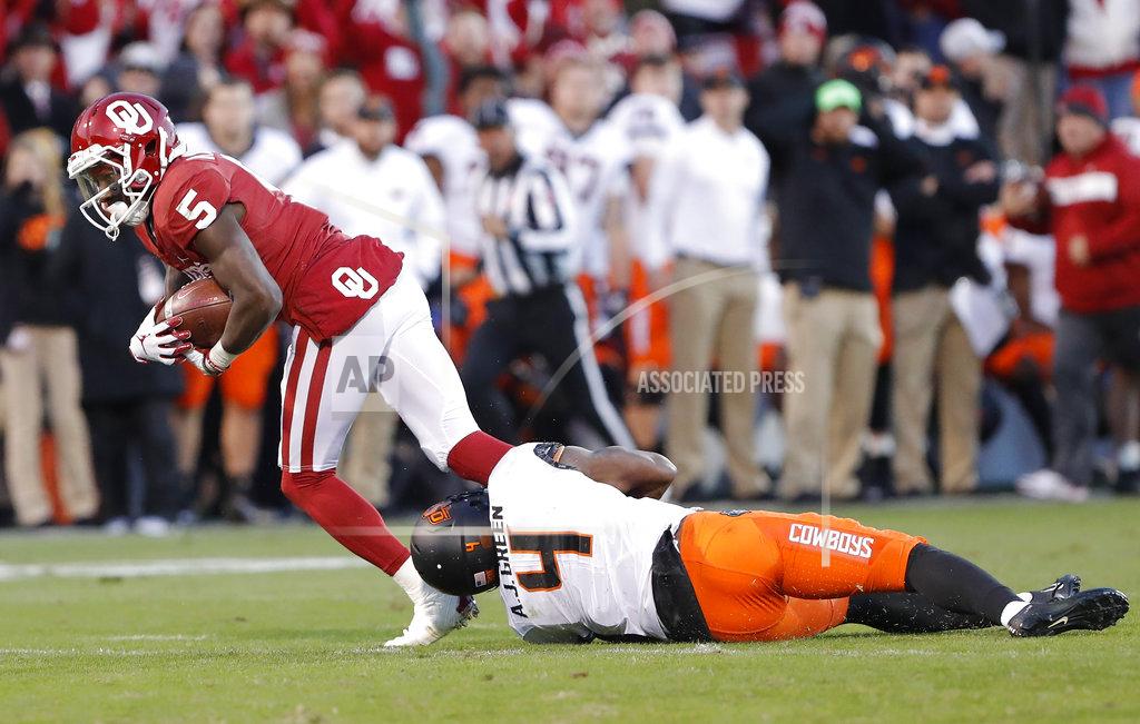 Alonzo Adams Oklahoma wide receiver Marquise Brown (5) is tackled by Oklahoma State cornerback A.J. Green (4) in the second half of an NCAA college football game in Norman, Okla., Saturday, Nov. 10, 2018. Oklahoma won 48-47. (AP Photo/Alonzo Adams)