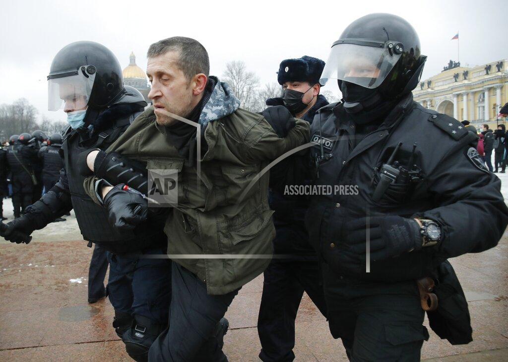 Dmitri Lovetsky Police detain a man during a protest against the jailing of opposition leader Alexei Navalny in St.Petersburg, Russia, Saturday, Jan. 23, 2021. Russian police on Saturday arrested hundreds of protesters who took to the streets in temperatures as low as minus-50 C (minus-58 F) to demand the release of Alexei Navalny, the country's top opposition figure. A Navalny, President Vladimir Putin's most prominent foe, was arrested on Jan. 17 when he returned to Moscow from Germany, where he had spent five months recovering from a severe nerve-agent poisoning that he blames on the Kremlin. (AP Photo/Dmitri Lovetsky)