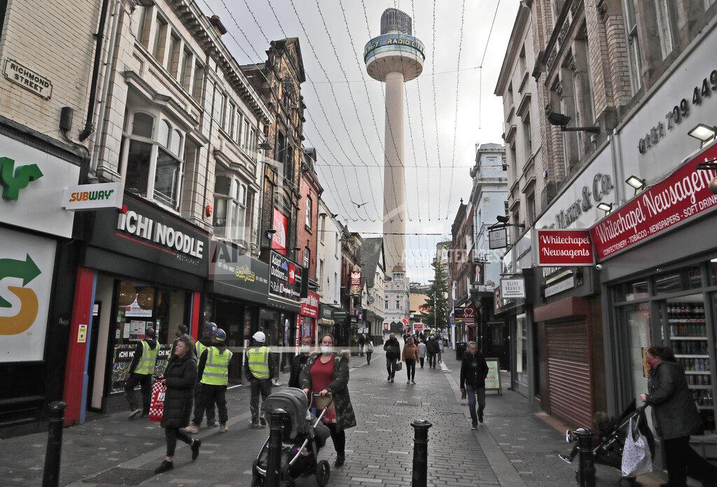 Frank Augstein People walk down a shopping street in Liverpool, England, Wednesday, Oct. 14, 2020. As the first area in England slapped with strict new restrictions to curb the resurgent coronavirus that have shuttered pubs and imperiled thousands of jobs, Liverpool again feels it's being punished by policies made in Britain's capital, 180 miles (290 kilometers) to the south. (AP Photo/Frank Augstein)