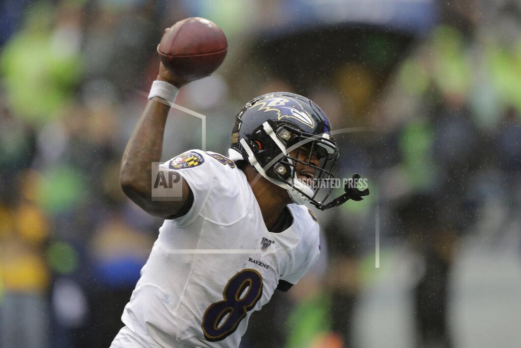 Baltimore Ravens quarterback Lamar Jackson (8) spikes the ball after a touchdown during the second half of an NFL football game against the Seattle Seahawks, Sunday, Oct. 20, 2019, in Seattle. (AP Photo/John Froschauer)