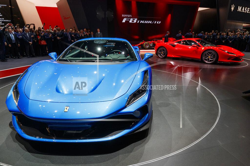 Cyril Zingaro Visitors look at the new 'Ferrari F8 Triturbo' during the press day at the '89th Geneva International Motor Show' in Geneva, Switzerland, Tuesday, March 05, 2019. The 'Geneva International Motor Show' takes place in Switzerland from March 7 until March 17, 2019. Automakers are rolling out new electric and hybrid models at the show as they get ready to meet tougher emissions requirements in Europe - while not forgetting the profitable and popular SUVs and SUV-like crossovers. (Cyril Zingaro/Keystone via AP)