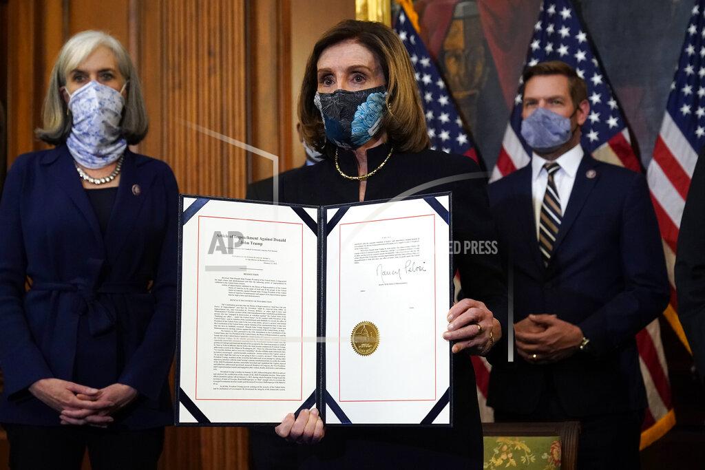 Alex Brandon House Speaker Nancy Pelosi of Calif., displays the signed article of impeachment against President Donald Trump in an engrossment ceremony before transmission to the Senate for trial on Capitol Hill, in Washington, Wednesday, Jan. 13, 2021. (AP Photo/Alex Brandon)