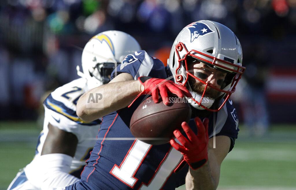 Charles Krupa New England Patriots wide receiver Julian Edelman (11) catches a pass in front of Los Angeles Chargers defensive back Desmond King during the first half of an NFL divisional playoff football game, Sunday, Jan. 13, 2019, in Foxborough, Mass. (AP Photo/Charles Krupa)