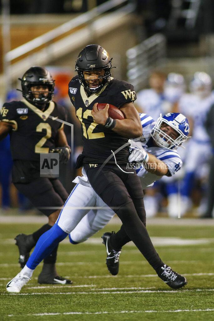 Nell Redmond Wake Forest quarterback Jamie Newman (12) breaks free from Duke linebacker Xander Gagnon as he carries the football in the second half of an NCAA college football game in Winston-Salem, N.C., Saturday, Nov. 23, 2019. Wake Forest won 39-27. (AP Photo/Nell Redmond)