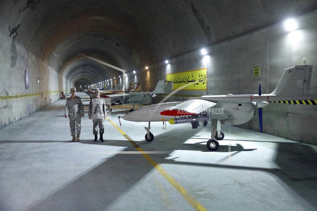 Uncredited In this photo released Saturday, May 28, 2022 by website of the Iranian Army, Chief of the General Staff of the Armed Forces Gen. Mohammad Hossein Bagheri, left, and Commander of the Army Gen. Abdolrahim Mousavi talk while visiting an underground drone base tunnel of the Army in the heart of the country's western Zagros Mountains. Iranian state television's report said Saturday, May 29, the tunnel was some 100 meters (330 feet) underground and was home to the Kaman-22 and Fotros drones, both capable of carrying cruise missiles. (Iranian Army via AP)