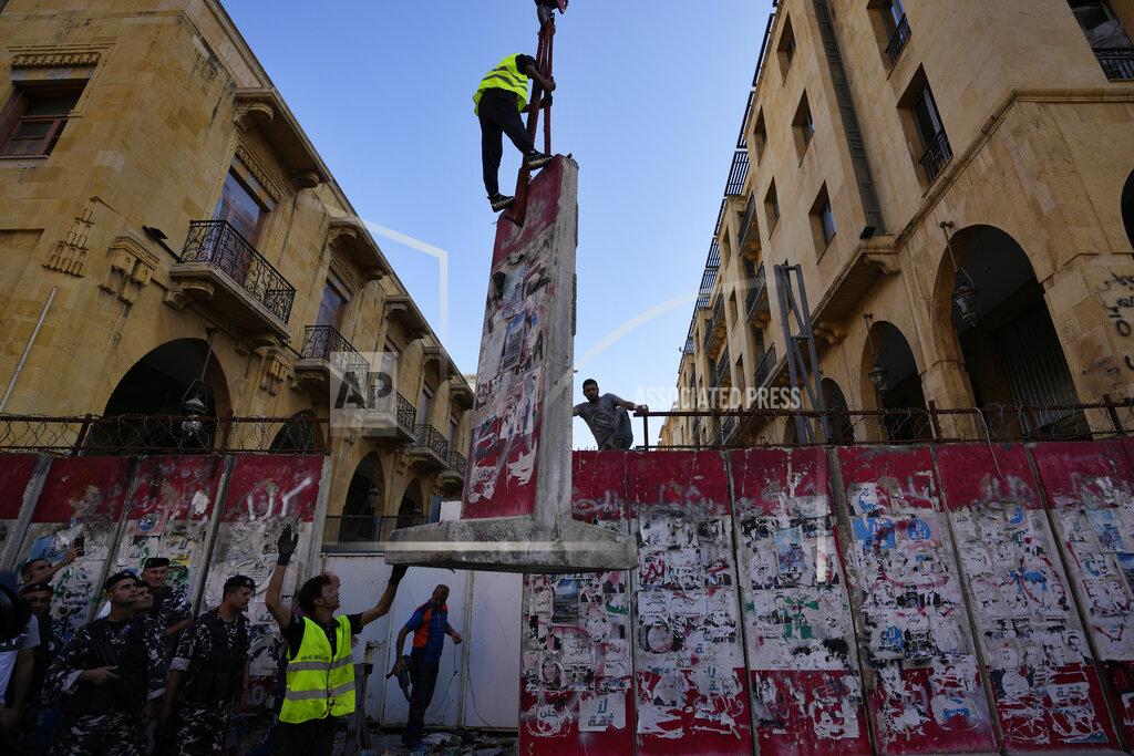 Hassan Ammar A team of engineers removes a concrete wall from a road that leads to the parliament building in Beirut, Lebanon, Monday, May 23, 2022. Lebanese authorities began removing giant cement barriers surrounding the parliament building in Beirut Monday, a week after a new legislature was elected. The blast walls were set up following nationwide protests that erupted in late 2019 amid an economic meltdown. (AP Photo/Hassan Ammar)