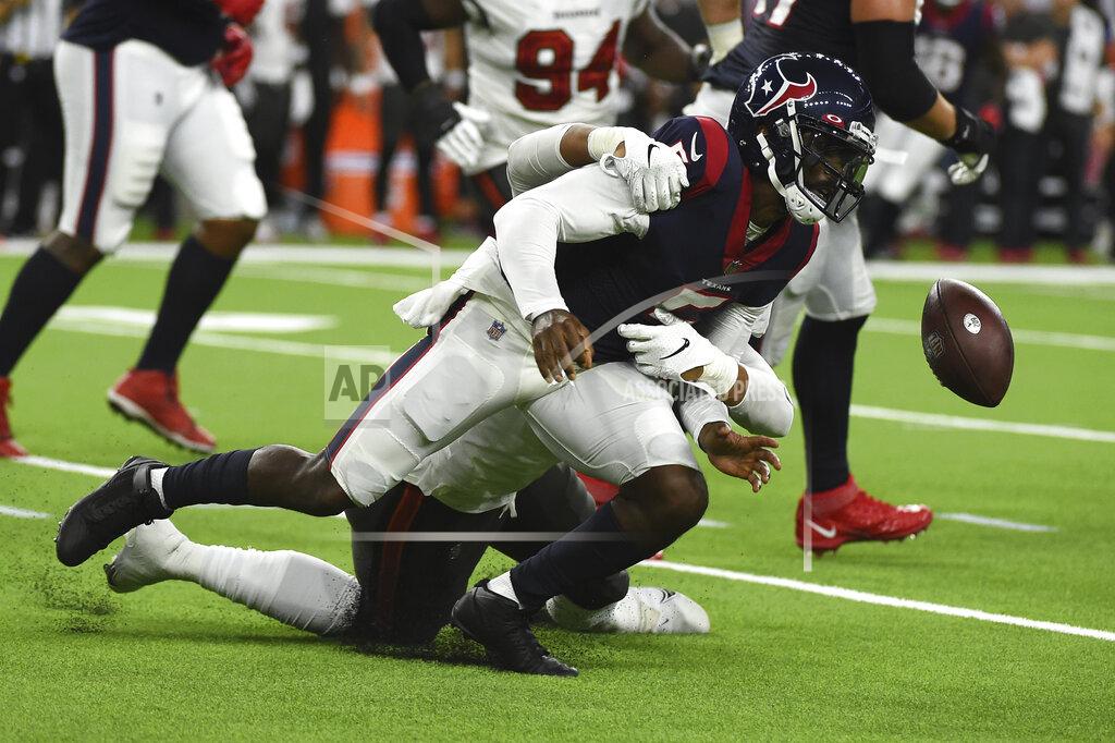 Eric Christian Smith Houston Texans quarterback Tyrod Taylor (5) fumbles the ball as he is hit by Tampa Bay Buccaneers' Joe Tryon-Shoyinka during the first half of an NFL preseason football game Saturday, Aug. 28, 2021, in Houston. The Buccaneers recovered the fumble. (AP Photo/Eric Christian Smith)