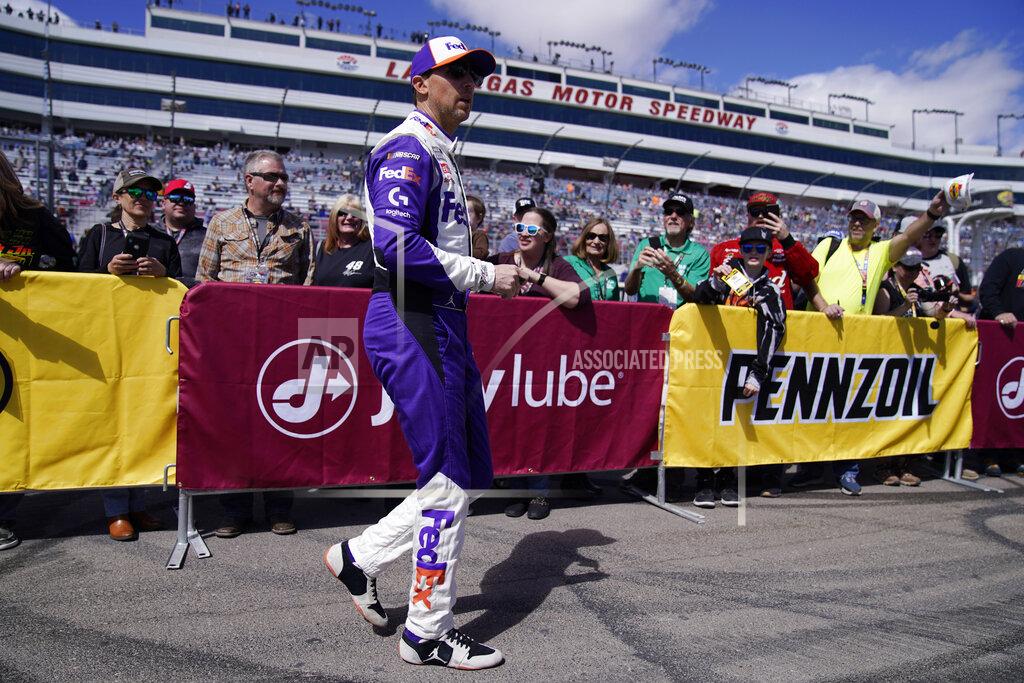 John Locher Driver Denny Hamlin greets fans before a NASCAR Cup Series auto race Sunday, March 6, 2022, in Las Vegas. (AP Photo/John Locher)